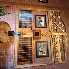 Rustic restaurant decor featuring wooden wall art and framed pictures
