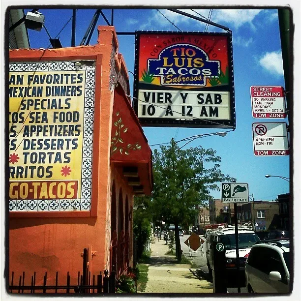Colorful exterior of Tio Luis Tacos restaurant with signage