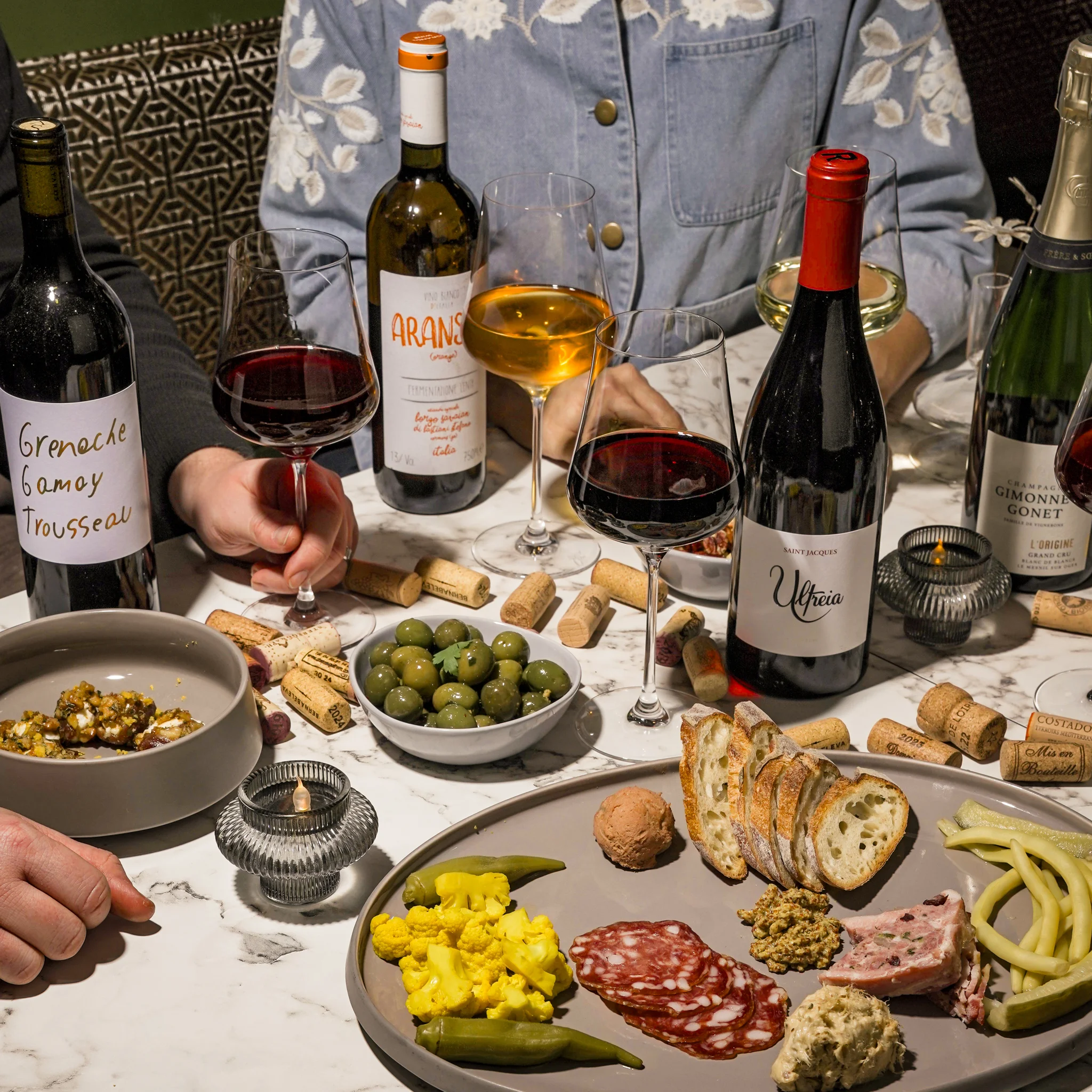 Charcuterie board with wine in a cozy dining setting