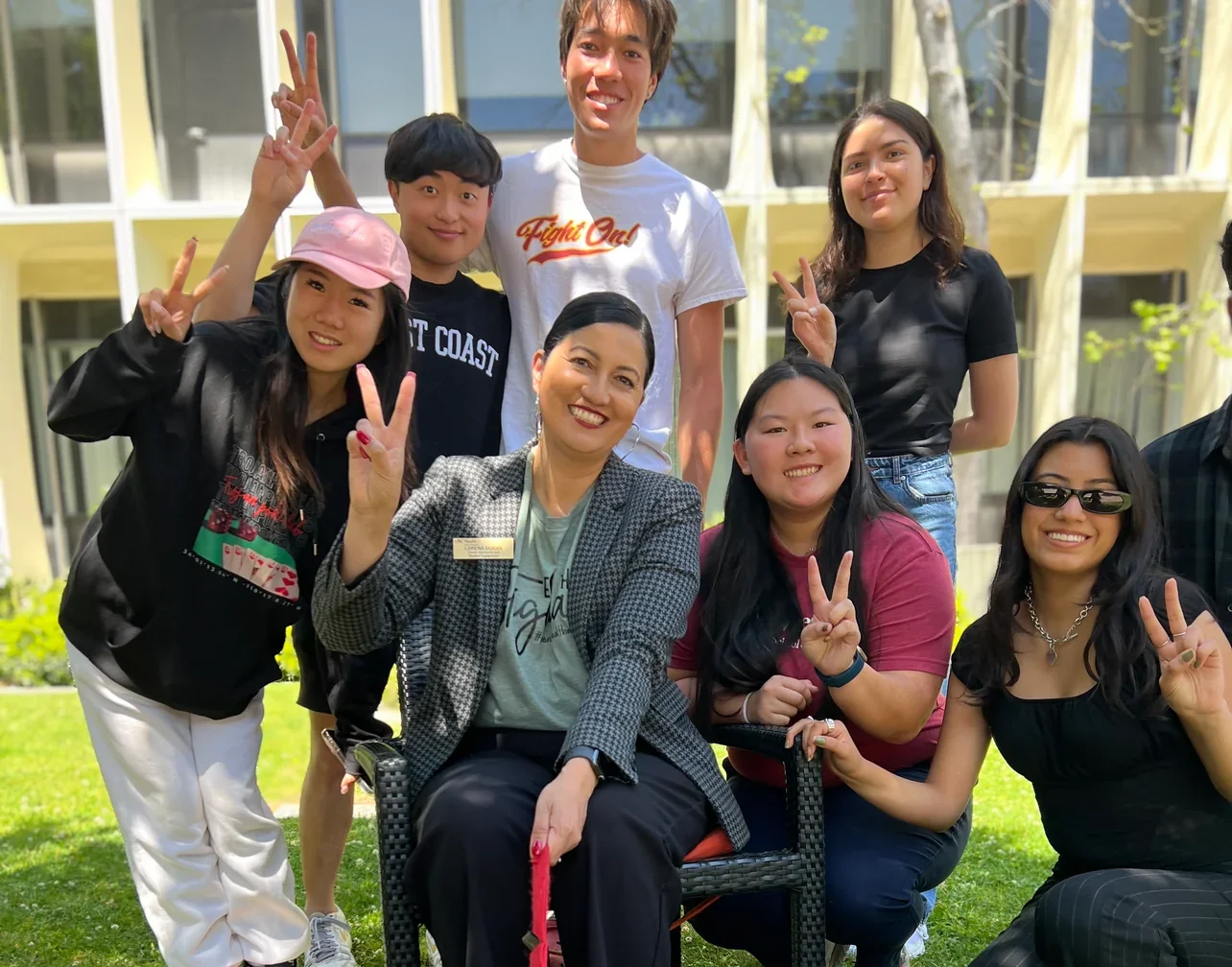 Group photo with friends and a dog in a park setting