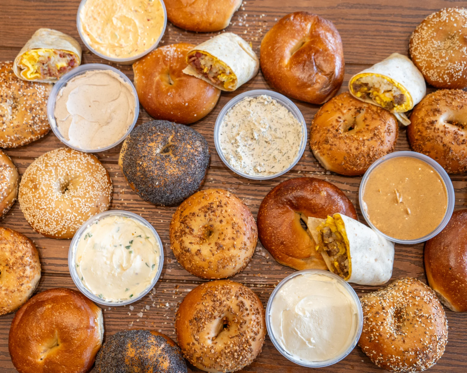 A delicious assortment of bagels displayed on a wooden board.