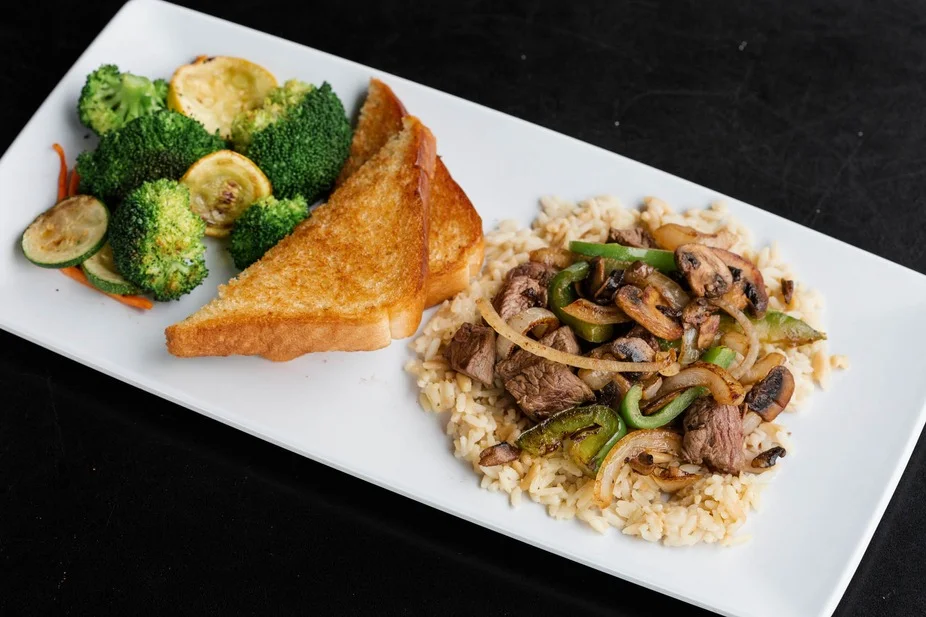 Sizzling beef stir-fry served with rice and vegetables