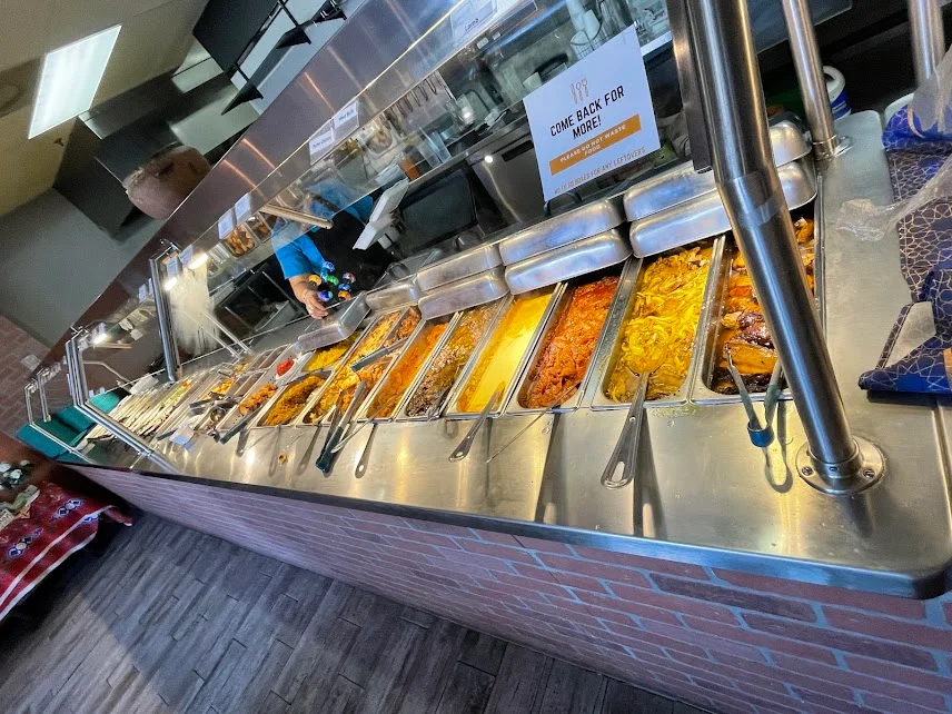 Buffet of diverse dishes in a vibrant restaurant setting