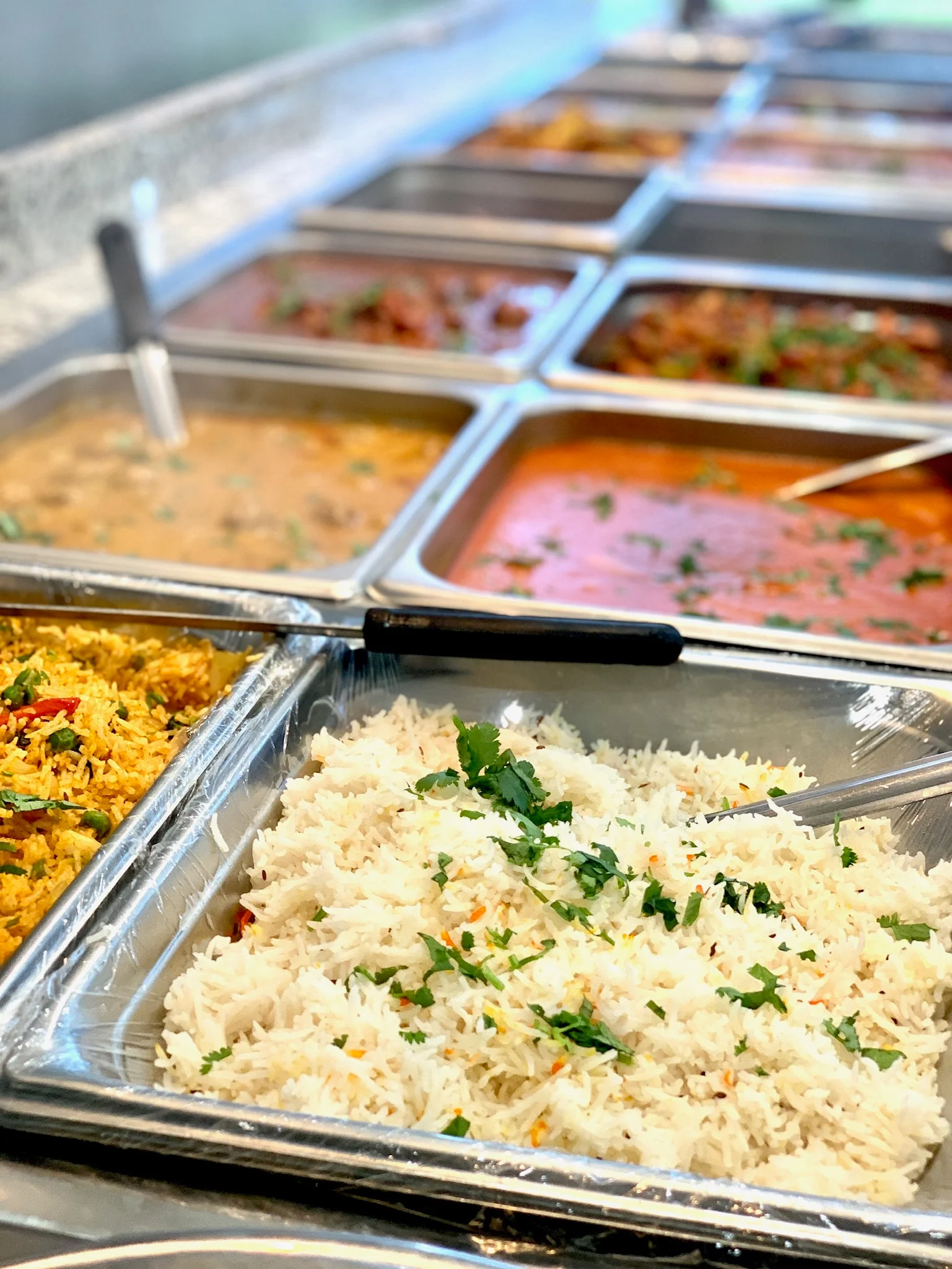 Assorted Indian curries and basmati rice in a buffet setting