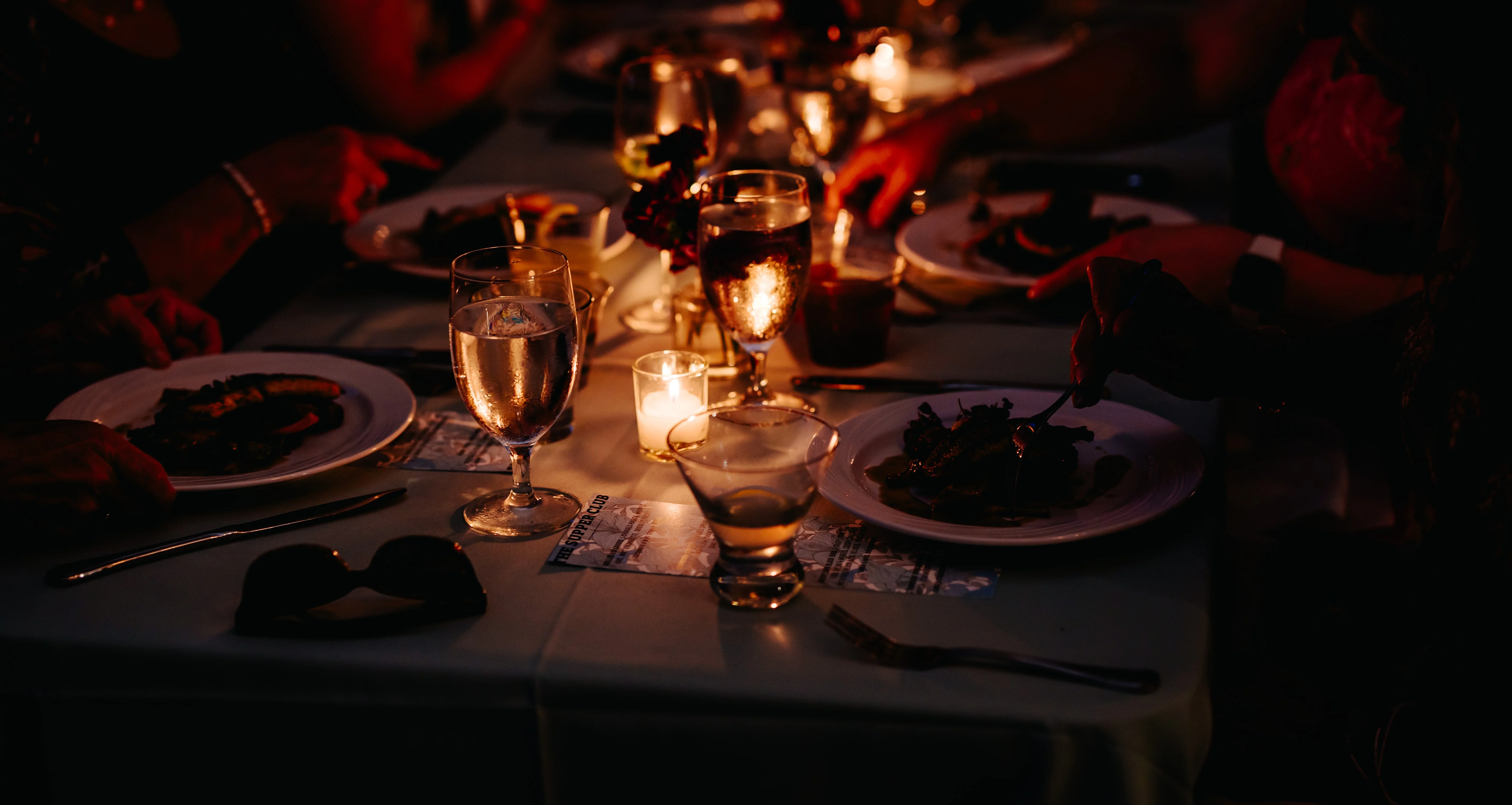 Elegant dining table with candlelight and gourmet dishes