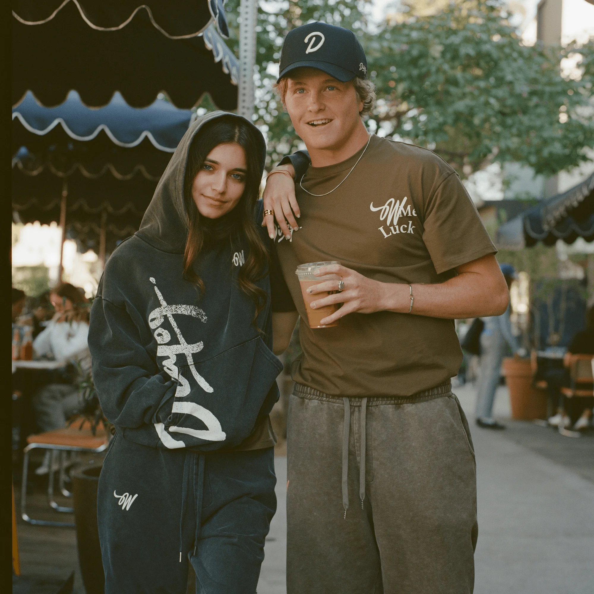 Casual couple posing outdoors in stylish streetwear