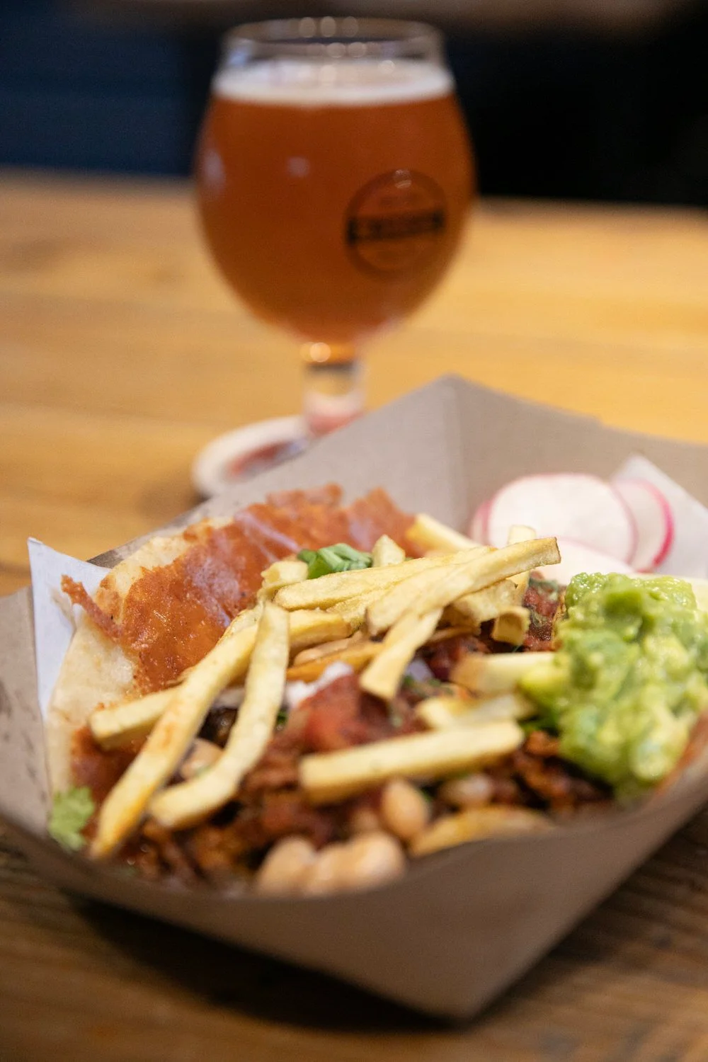 Loaded Mexican nachos with guacamole and fries