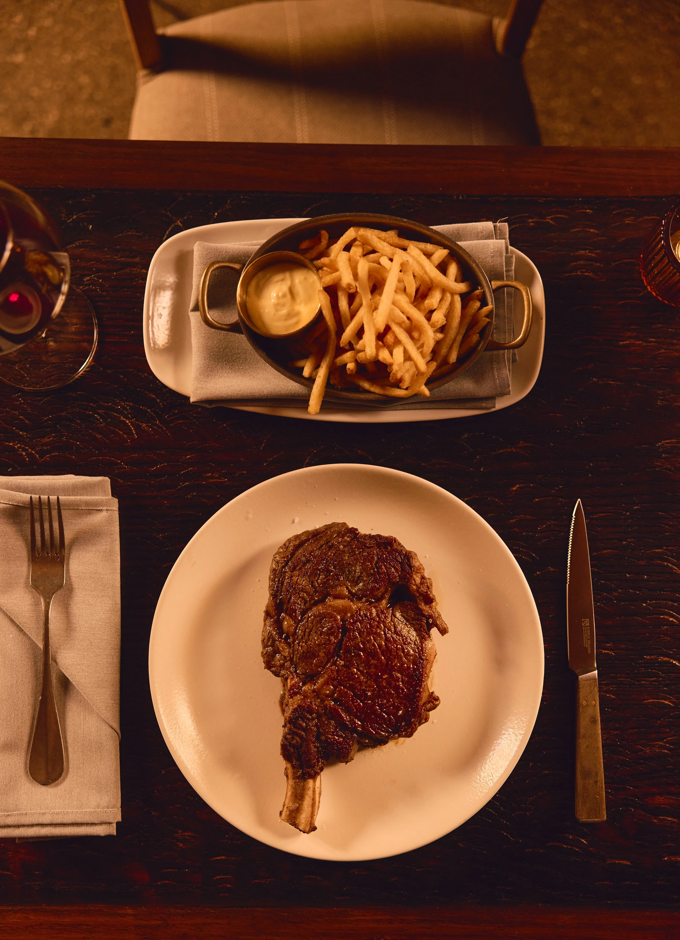 Juicy ribeye steak served with crispy French fries and aioli