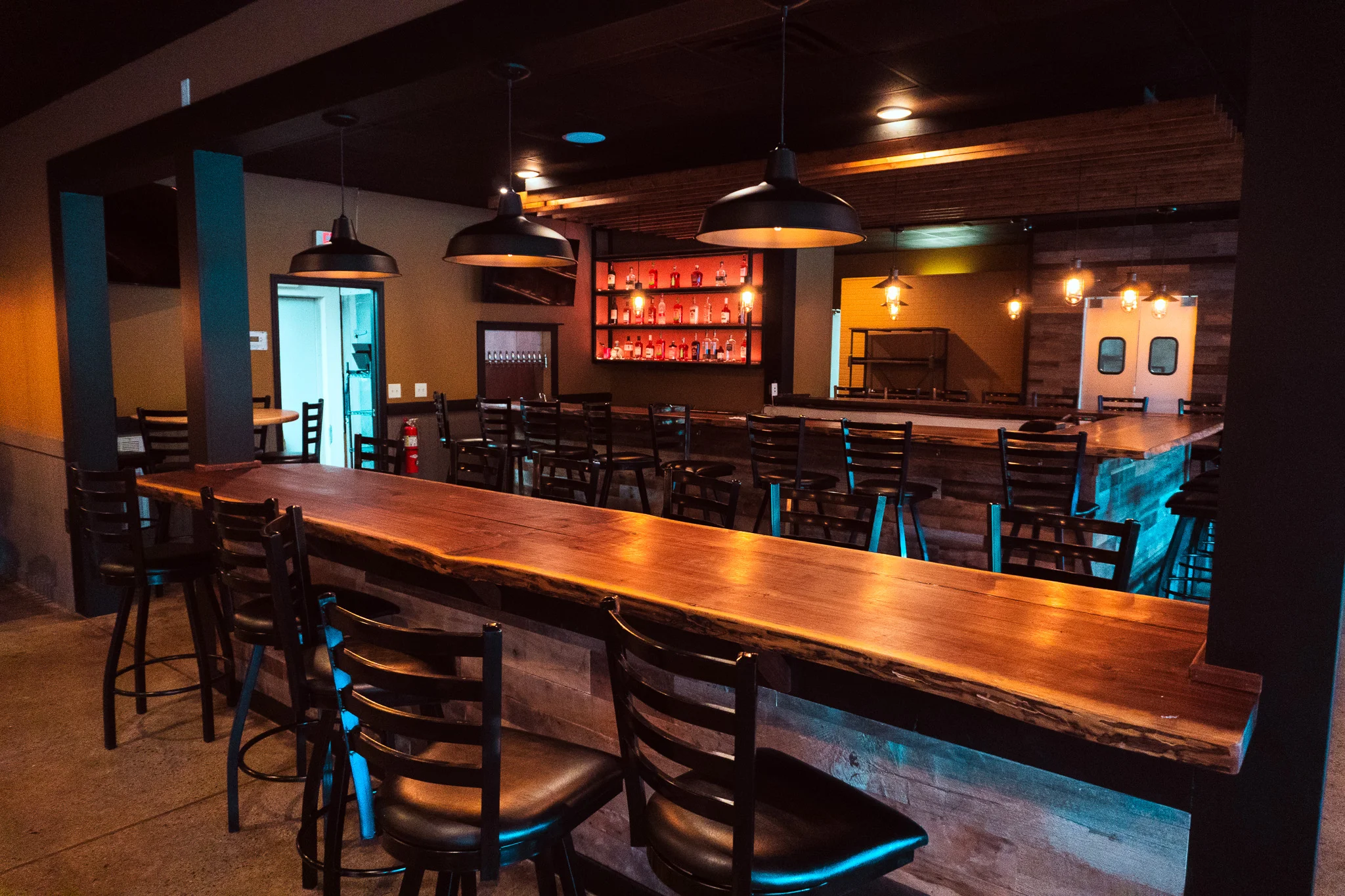 Modern bar interior with wooden counter and stylish lighting