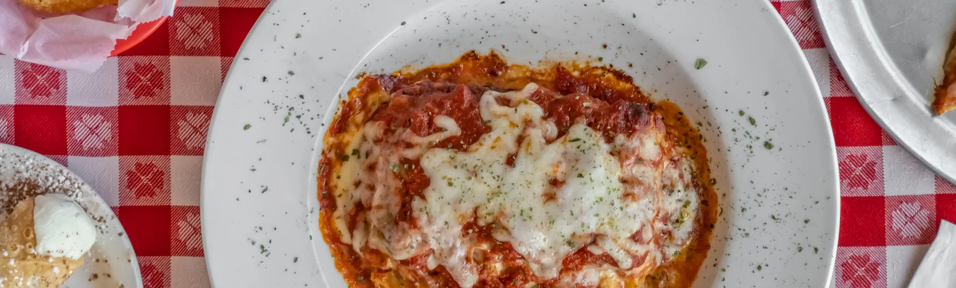 Italian lasagna with garlic bread and pepperoni pizza