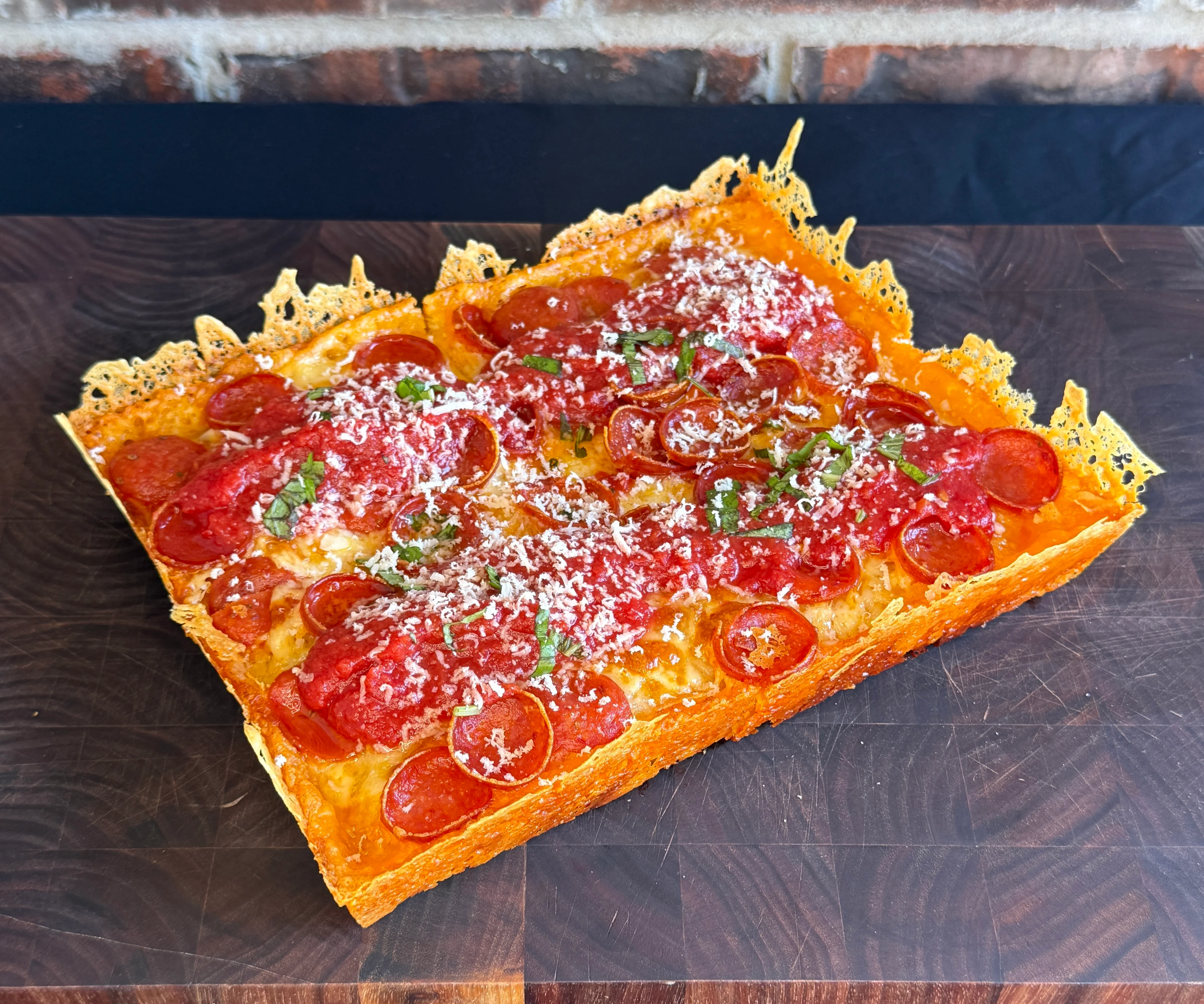 Delicious Detroit-style pizza with fresh toppings on a wooden table