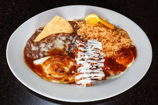 Plate of huevos rancheros with rice and beans