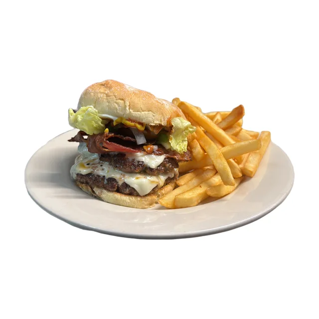 Juicy cheeseburger with fries on a plate