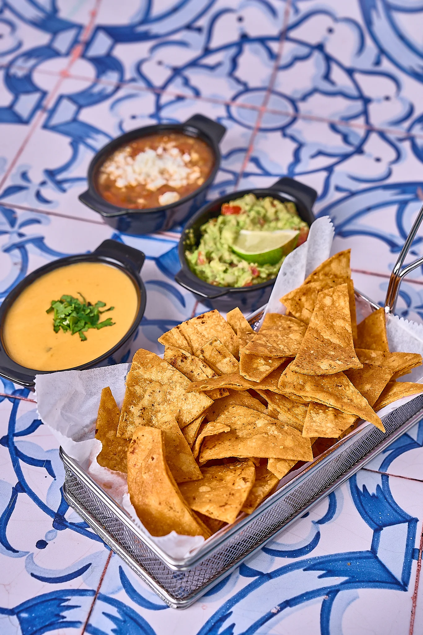 Crispy tortilla chips with guacamole and cheese dip