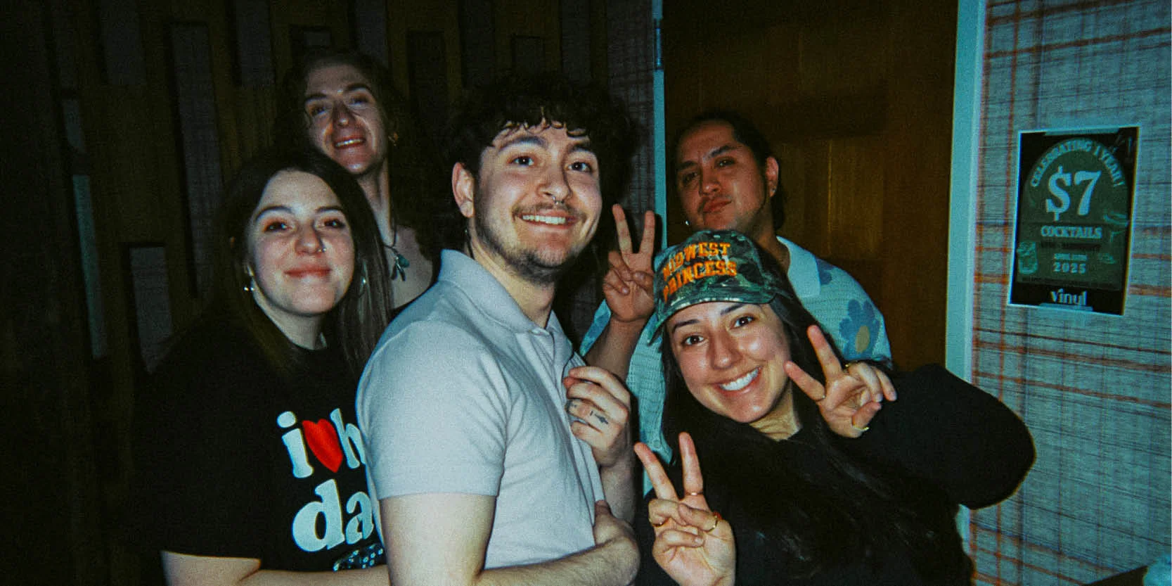 Group of friends posing happily at a bar