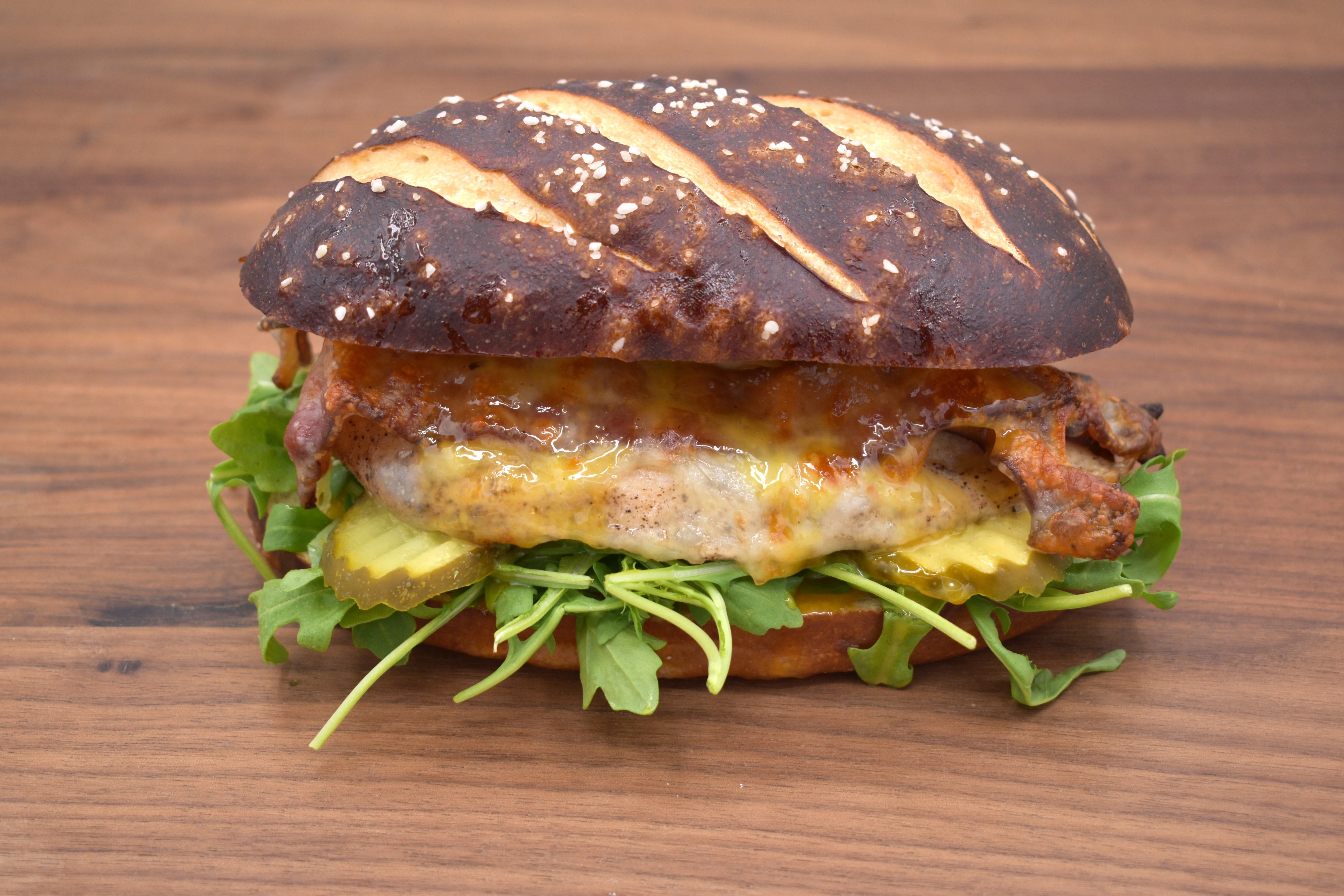 Extreme close-up of a grilled sandwich with greens and sauce