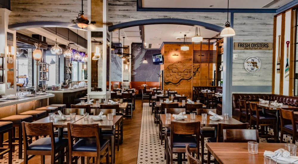 Stylish restaurant interior with wooden tables and bar seating
