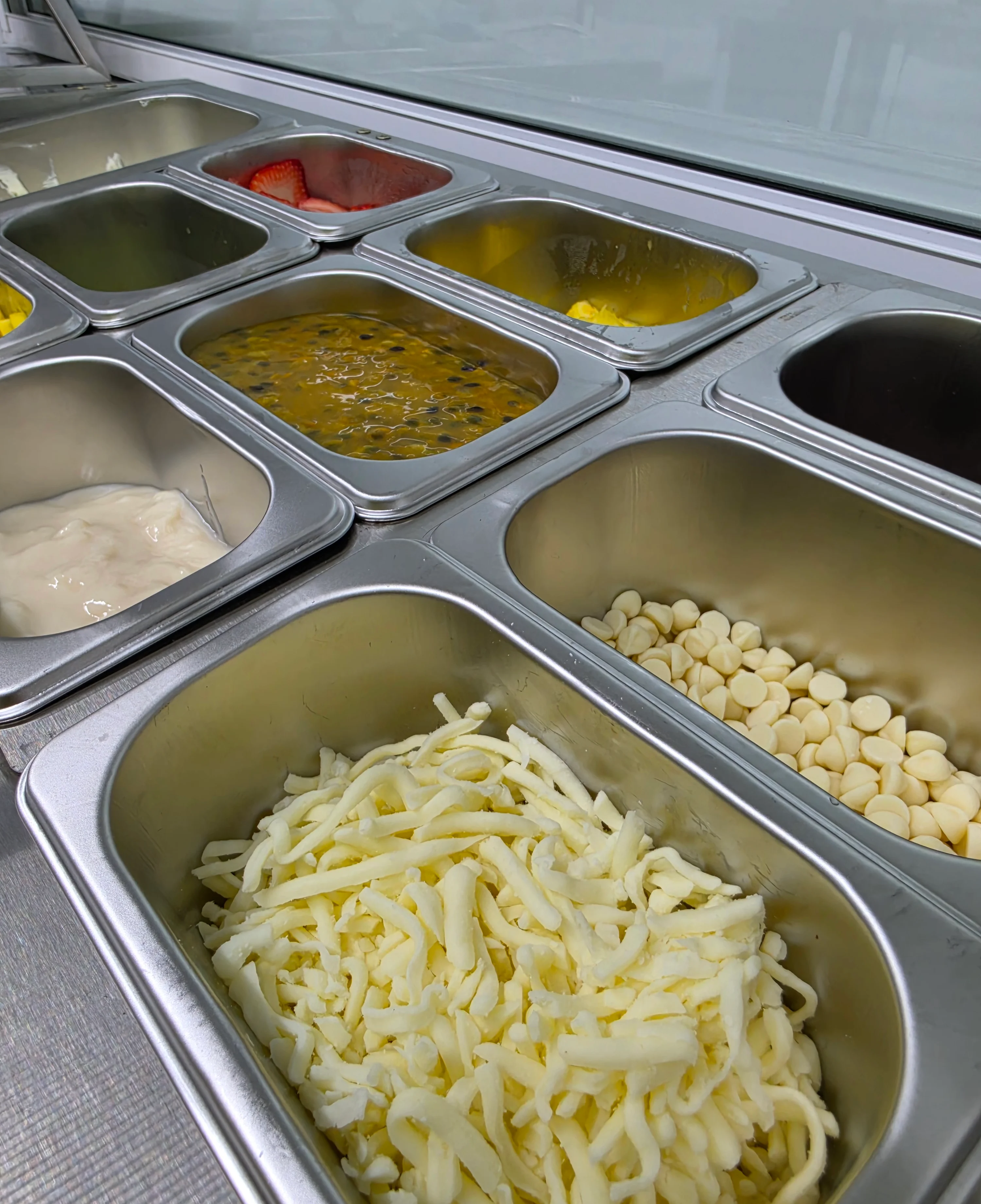 Assorted toppings for Mexican tacos in stainless steel containers