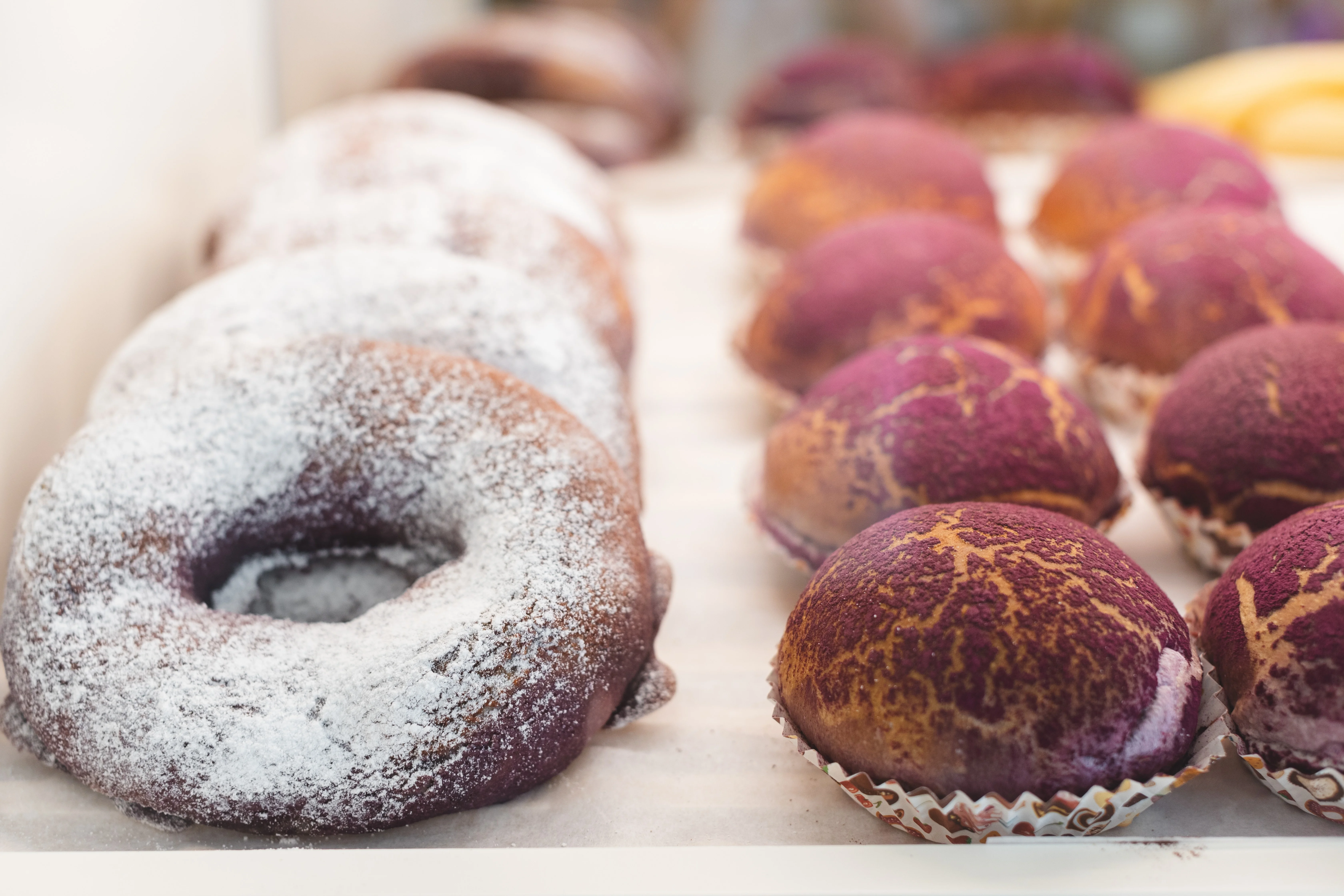 Purple ube donuts and pastries on display