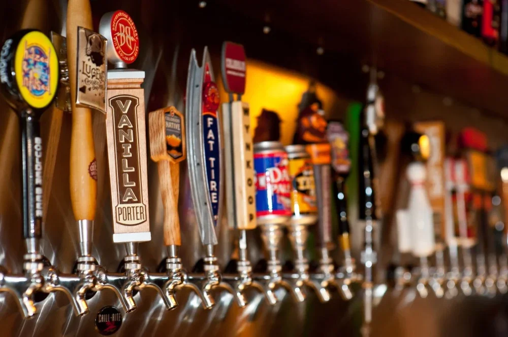 Variety of craft beer taps at a bar