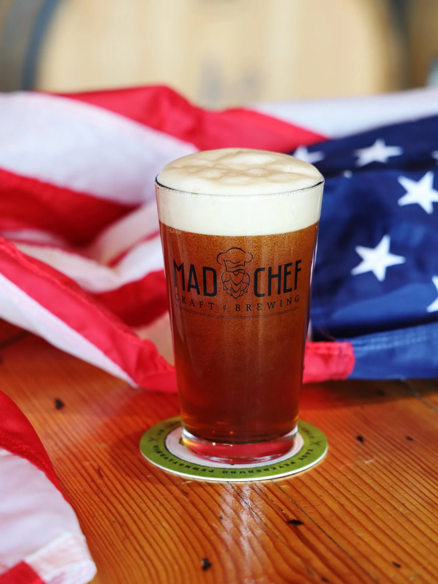 Craft beer in a glass with American flag backdrop