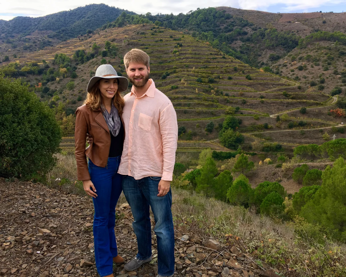 Couple posing in scenic vineyard landscape
