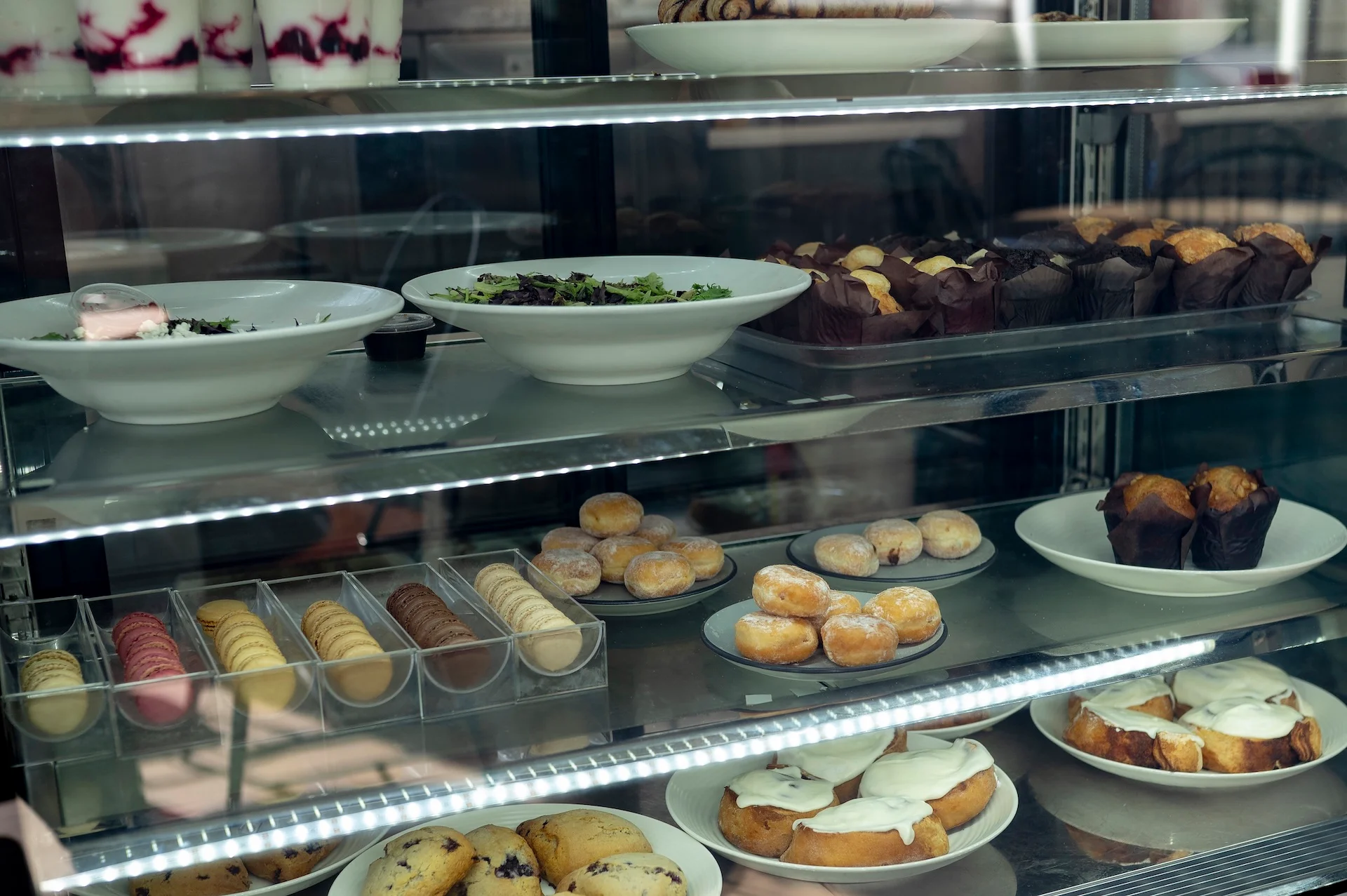 Assorted pastries and desserts in a bakery display case