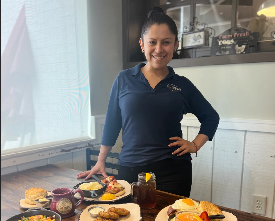 Friendly server at a cozy breakfast cafe with delicious brunch dishes