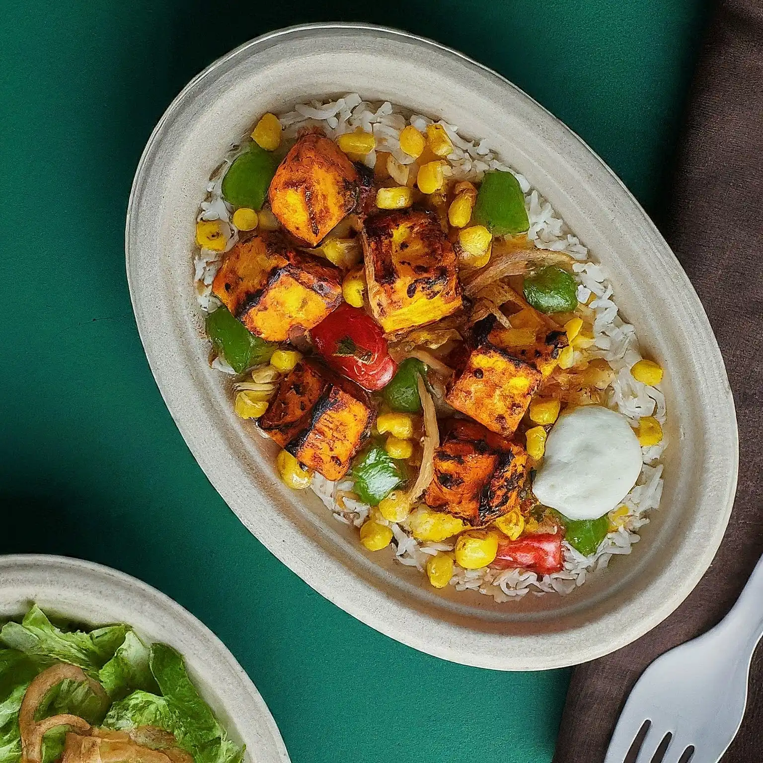 Indian Paneer and Chicken Bowl with Jeera Rice, Sauted Pepper, Onions and Sauce