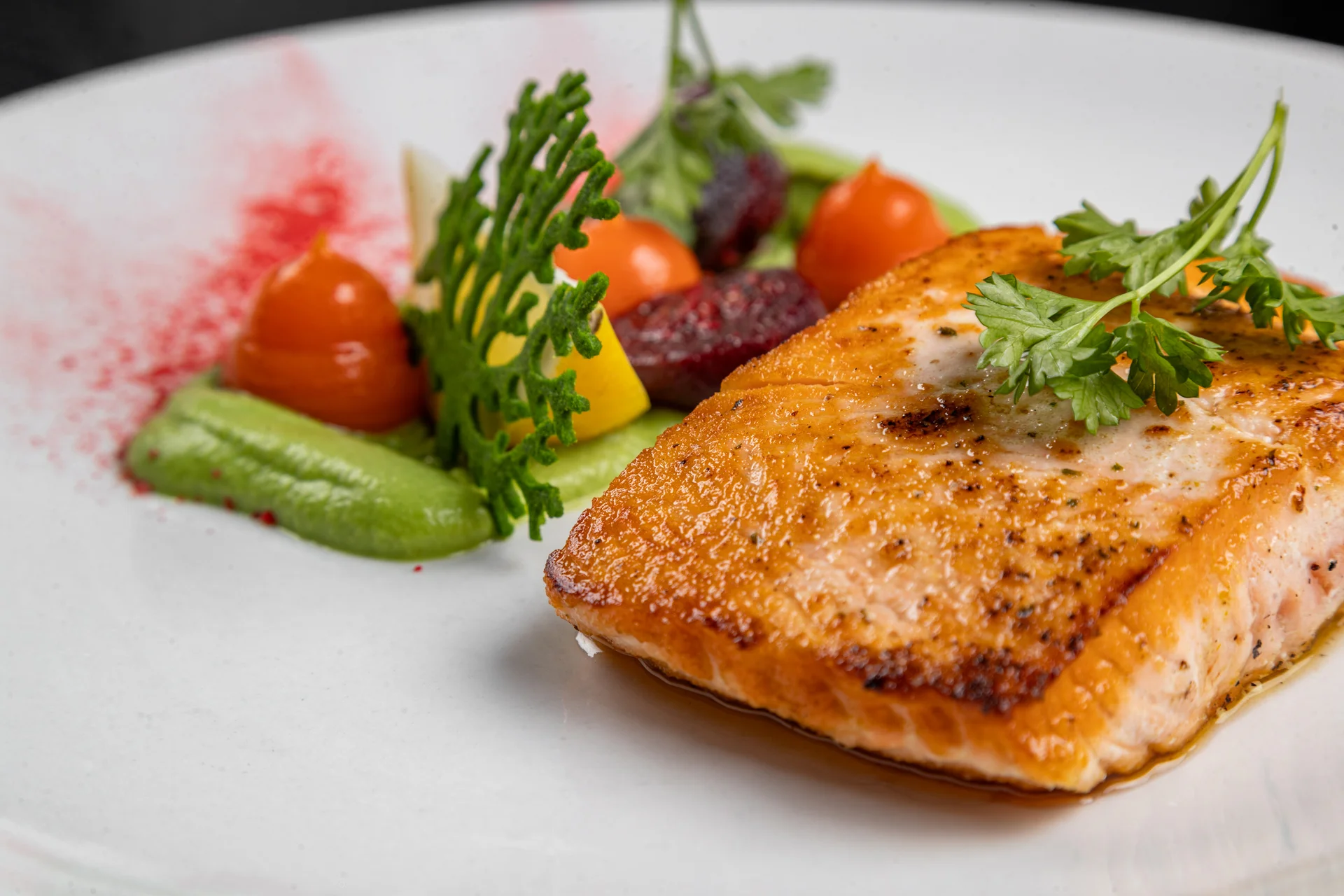 Grilled salmon fillet with vibrant vegetable garnish