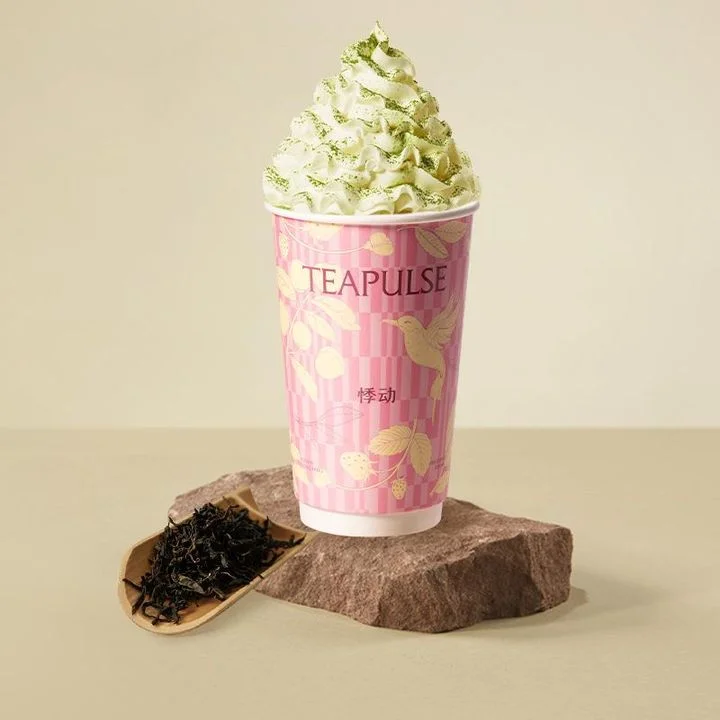 Matcha whipped cream drink in a decorative cup