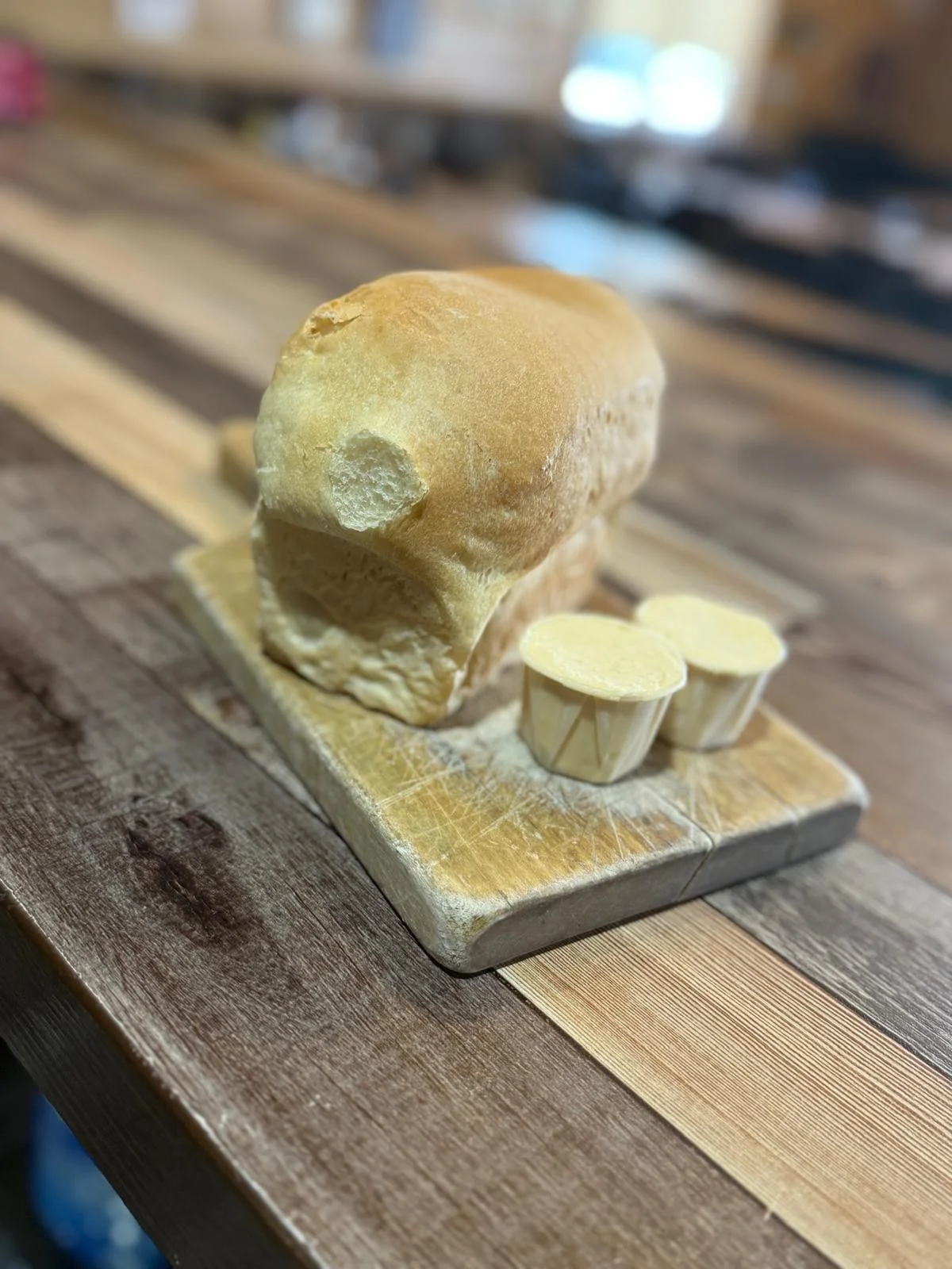 Freshly baked bread loaf with butter portions