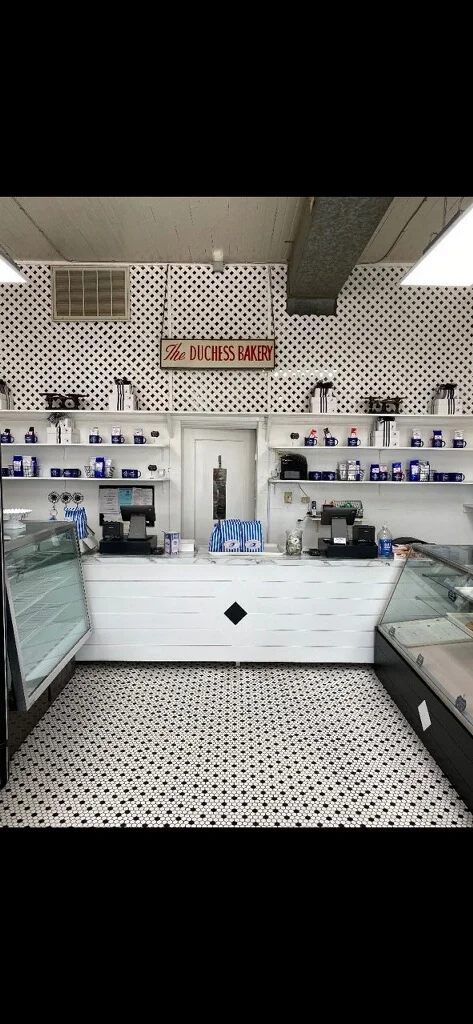 Charming bakery interior with white decor and patterned flooring