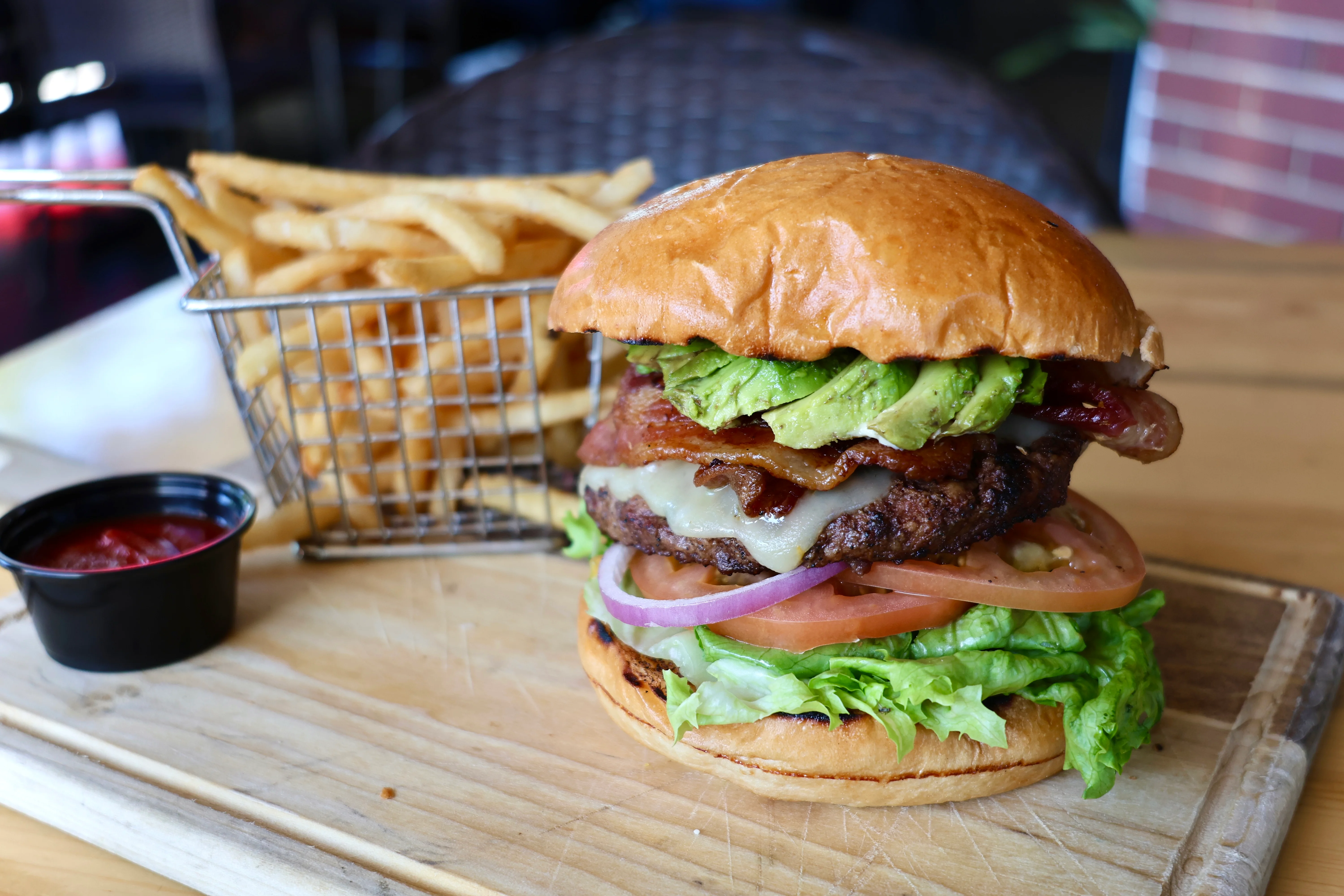 Juicy American cheeseburger with bacon and avocado