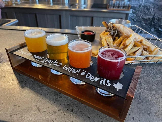 Craft beer flight with fries at a modern bar
