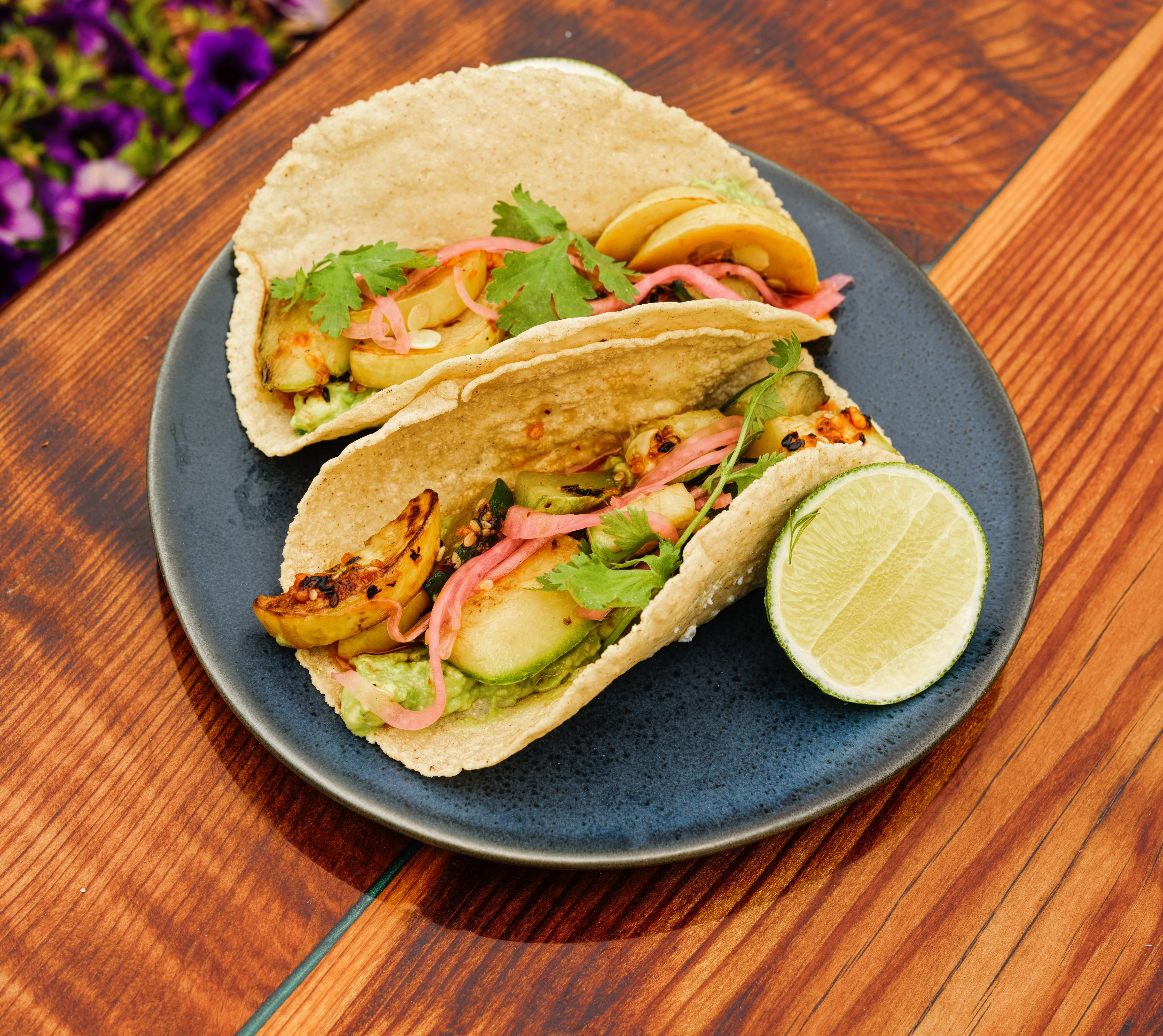 Delicious street tacos with grilled vegetables and lime