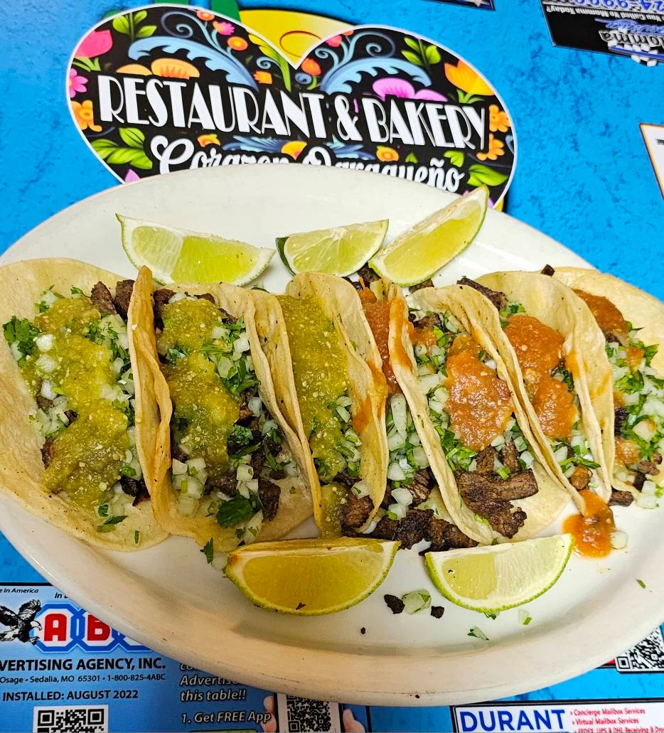 Authentic Mexican street tacos with salsa and lime wedges