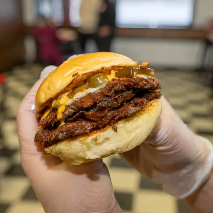 Juicy double cheeseburger with pickles and melted cheese
