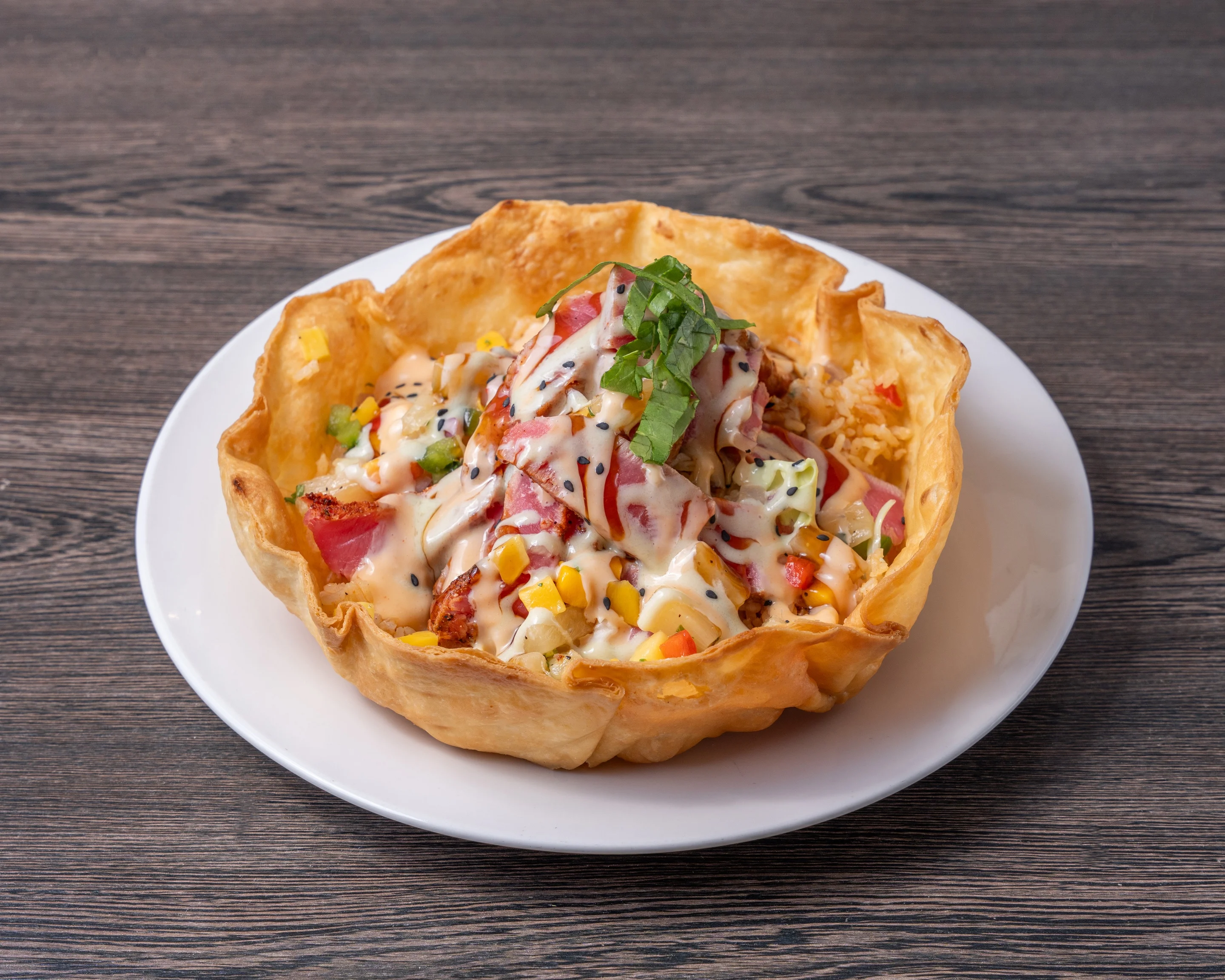 Colorful Mexican taco salad in a crispy tortilla bowl