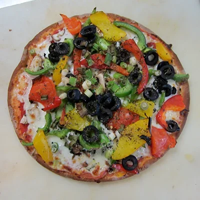 Colorful vegetarian pizza topped with bell peppers and olives