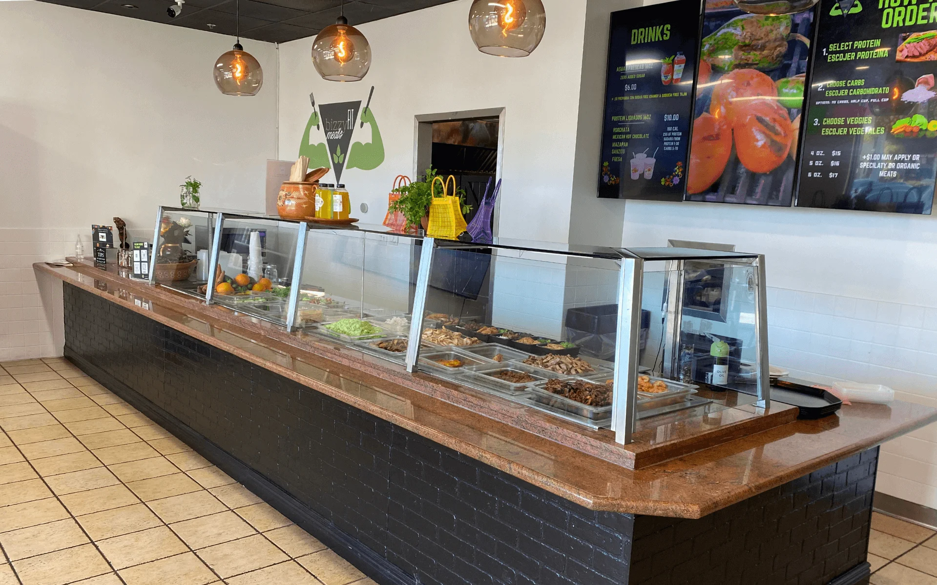 Modern restaurant counter with fresh ingredients and menu display