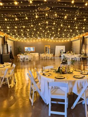 Elegant event space with twinkling lights and round tables
