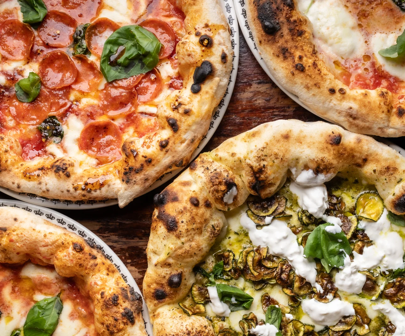 Assorted Neapolitan pizzas with fresh basil