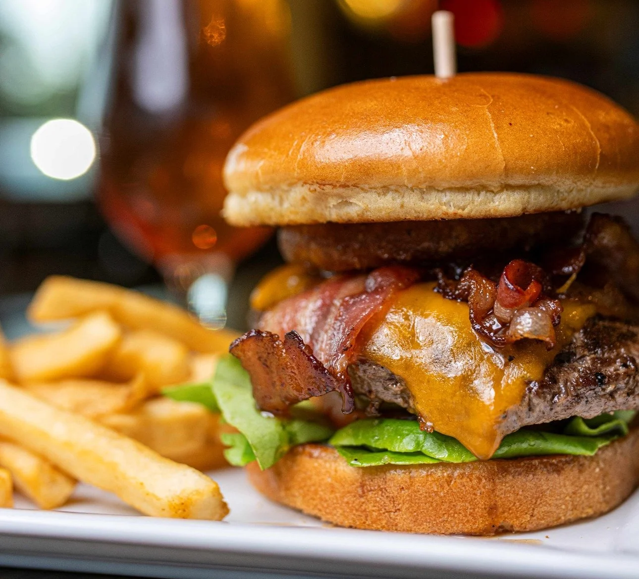 Juicy cheeseburger with bacon and fries