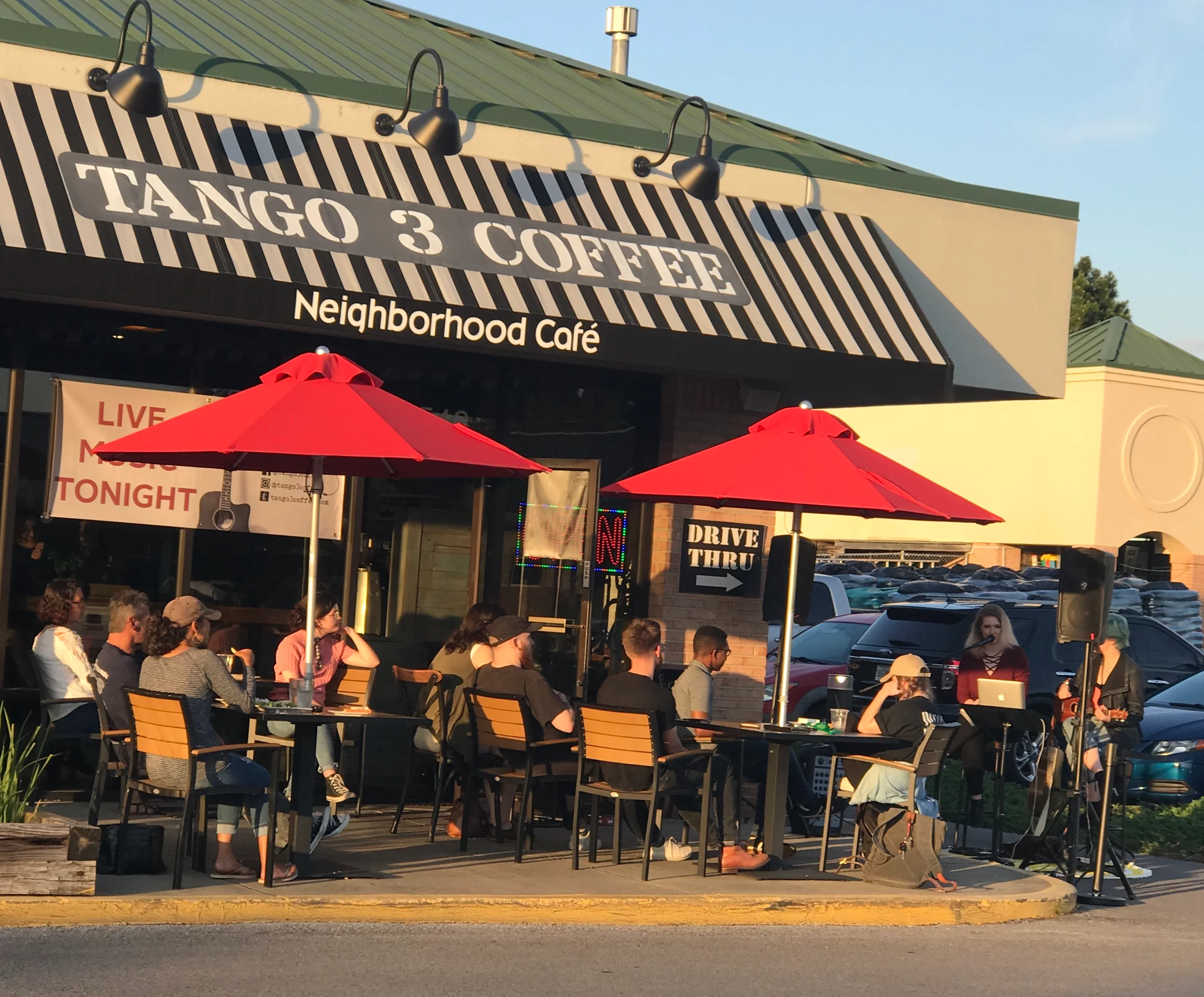 Outdoor café with live music and red umbrellas