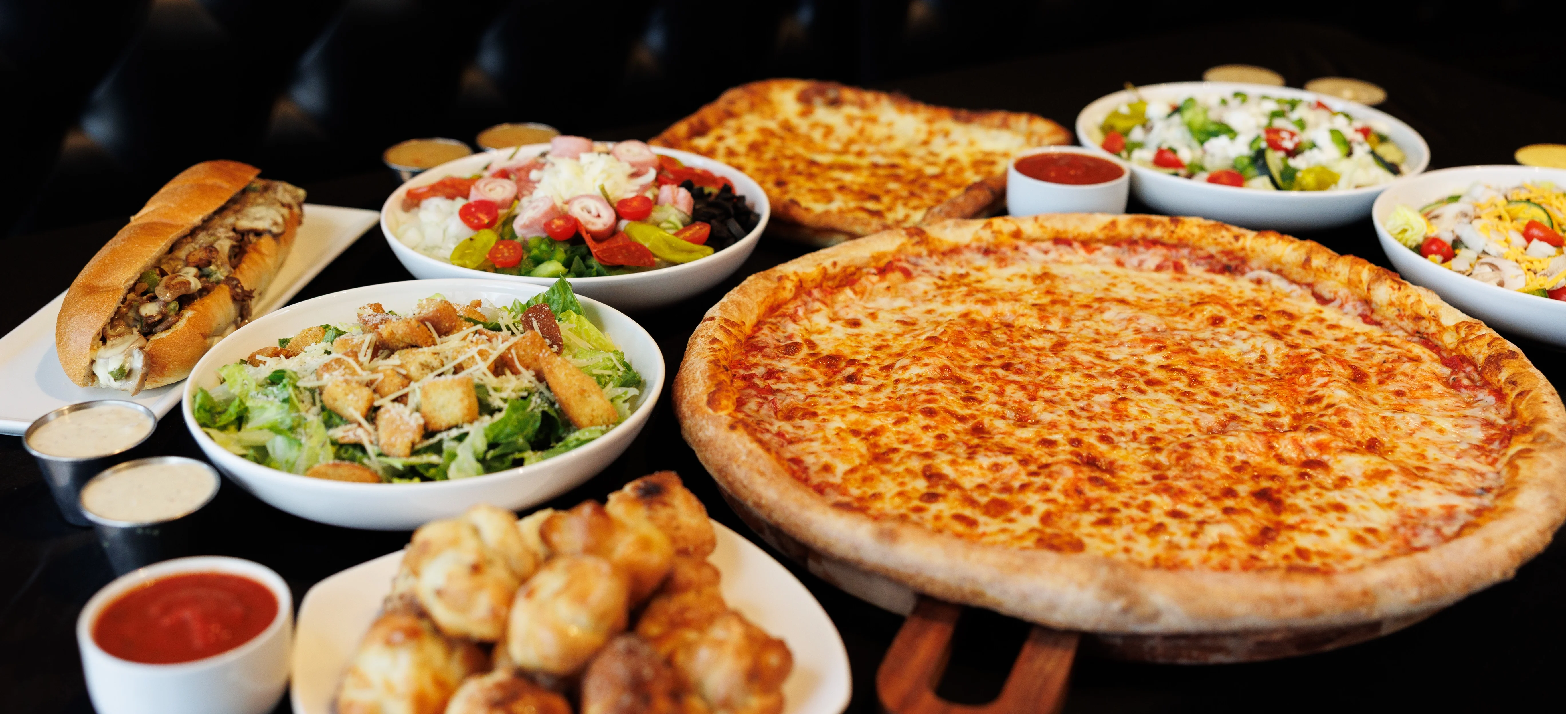 Delicious pepperoni pizza with wings and salad in a restaurant setting