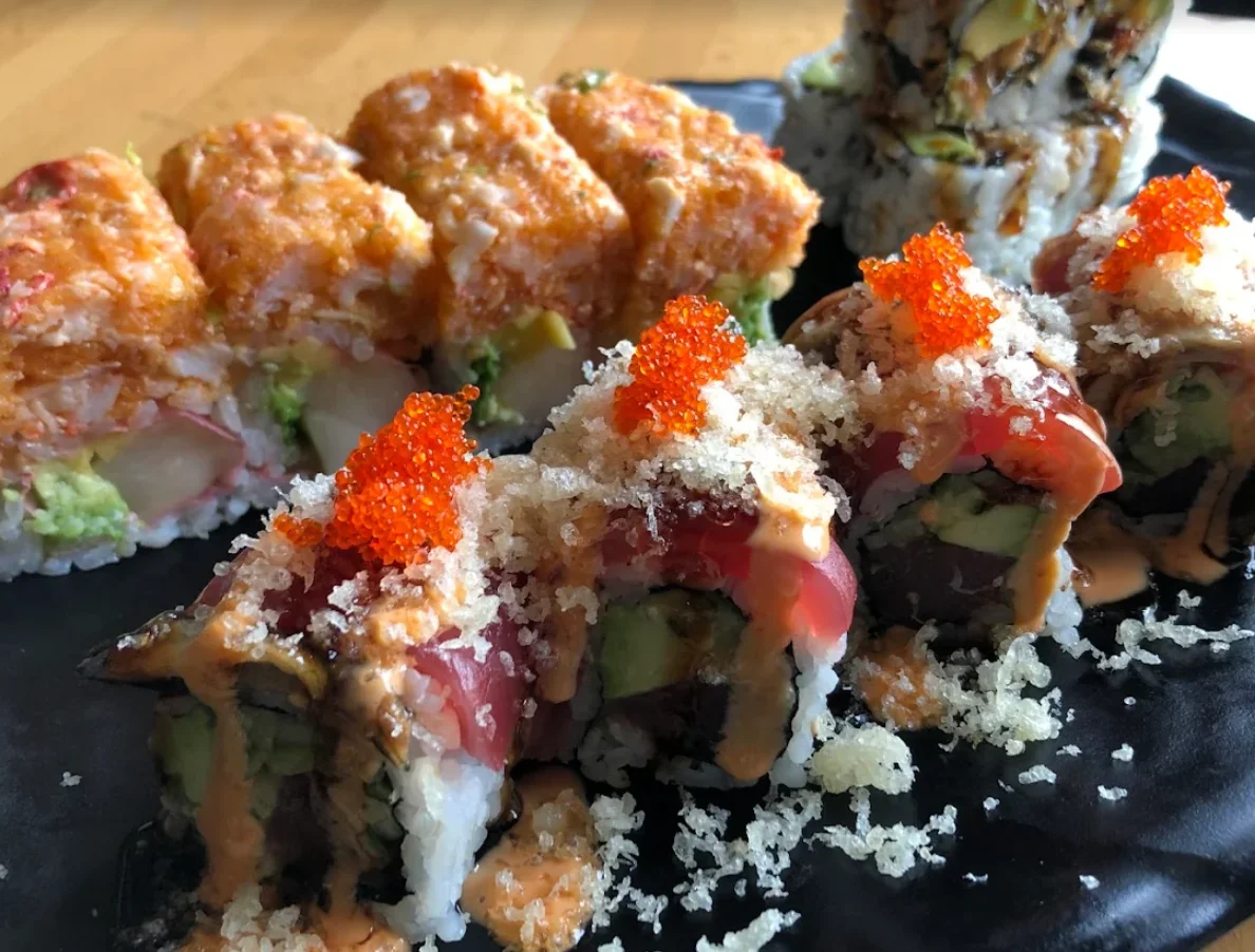 Assorted sushi rolls including spicy tuna and dragon roll