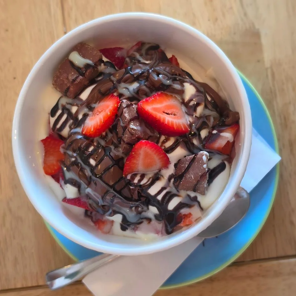 Delicious dessert bowl of chocolate-covered strawberries and cream