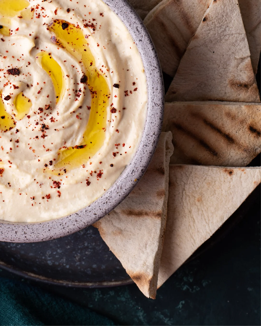 Creamy hummus served with warm pita bread