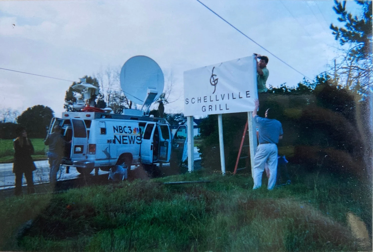 Schellville Grill sign installation with news crew